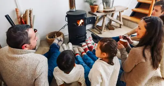 Family relaxing by the fireplace